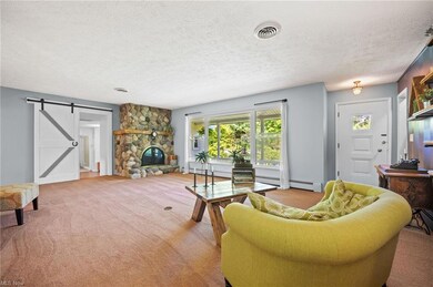 Step into this spacious Living Room featuring a Stone Fireplace.