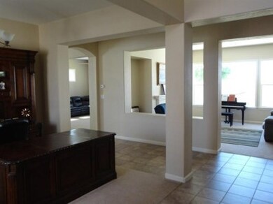 The wide open spaces of this exquiste home are stunning. Large Formal dining area, which can also be used as an office, columns and pillars separate the formal living room with cozy fireplace. The picture window warms the room with natural sun light.
