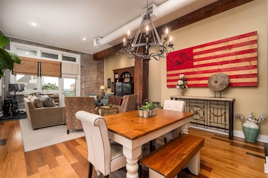 Dining room featuring wood finished floors and a chandelier