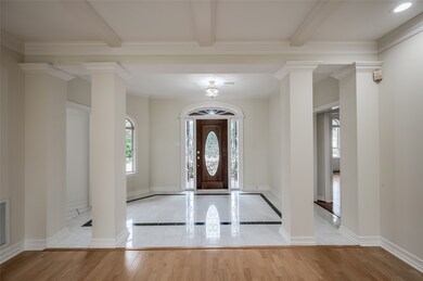Impressive leaded-glass and wood front door featur
