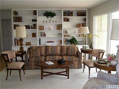 Spacious living room with picture window looking out to pool and yard.