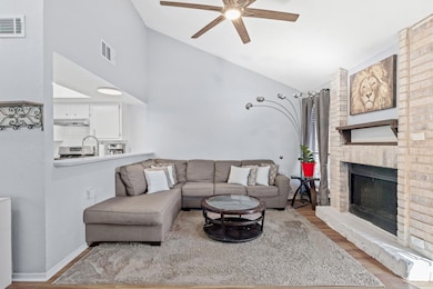 Living area with wood finished floors, ceiling fa
