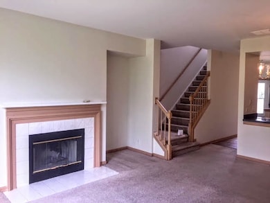 Large living room with wood burning fireplace.