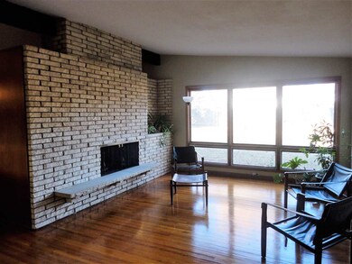 Living Area with Stone Fireplace & Huge Picture Wi
