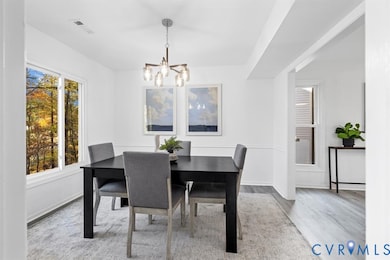 Dining area featuring a chandelier and light wood-style flooring