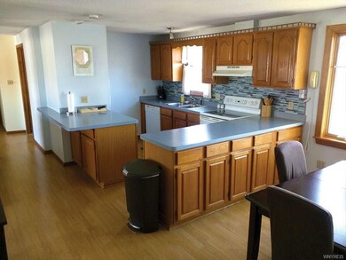Beautifully applianced Oak Kitchen features Lamina
