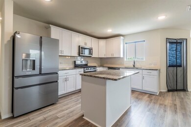 Kitchen featuring light wood finished floors, a si