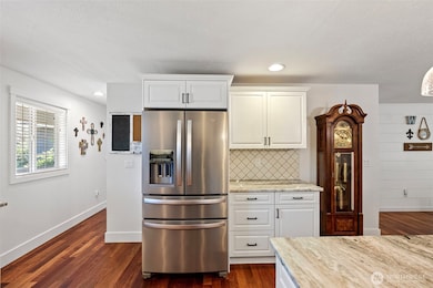 Main level kitchen with hall to front entryway.