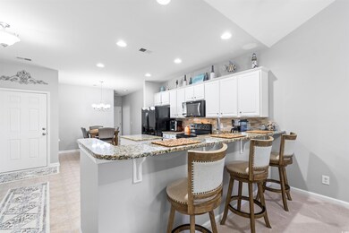 Kitchen featuring kitchen peninsula, white cabinet