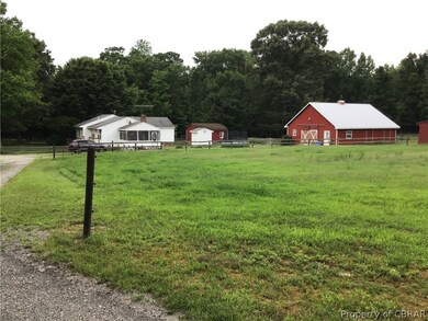 View of yard featuring a rural view and an outbuil