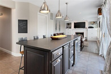 Kitchen island features a beverage refrigerator, b