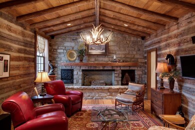 Reclaimed log from vintage cabin makes setting for rustic sitting room