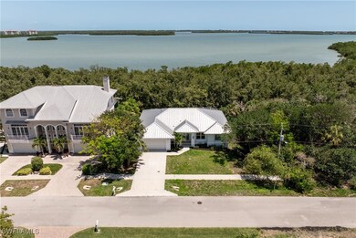 Aerial view of property and surrounding area featuring a large body of water