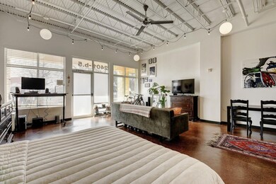 Living area with a towering ceiling, concrete flo