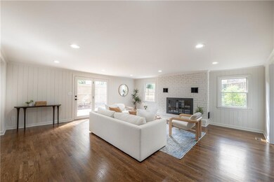The home features two living spaces — including am oversized family room with a wood-burning fireplace.