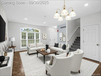 Living area with recessed lighting, stairs, dark wood-style floors, and a chandelier