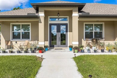 Front porch sitting. Beautiful double door entry for ease of moving as well as lots of natural light into the custom 2020 built home.