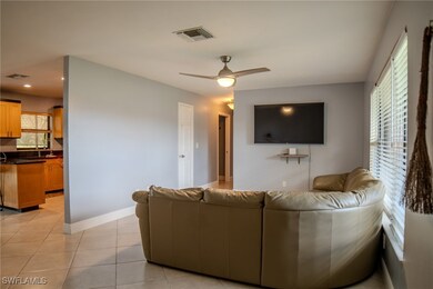 Tiled living room with ceiling fan and plenty of n