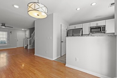 Kitchen featuring decorative light fixtures, appli