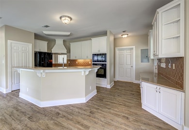 Kitchen featuring black appliances, backsplash, e