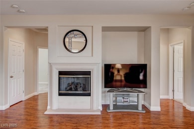 Relax in front of the fireplace and media niche.