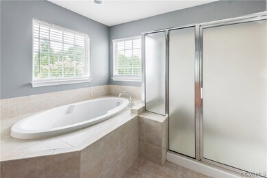 View of the tiled tub and shower area.