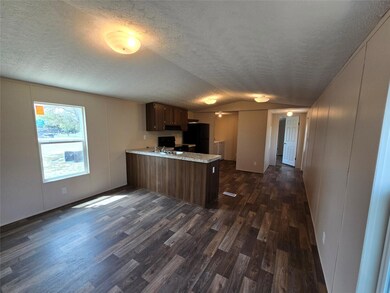 Kitchen featuring vaulted ceiling, a peninsula, l