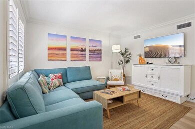 Living room featuring ornamental molding and light