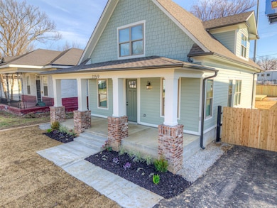 View of front of house featuring covered porch, ro