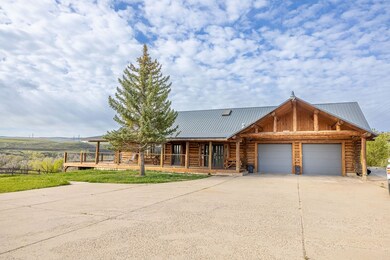 Log-style house featuring a garage