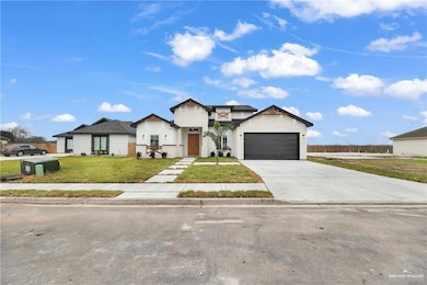 View of front of home with a front lawn and a garage