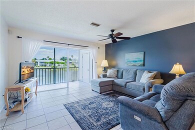 Living room with a textured ceiling, light tile pa