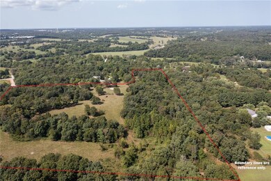 The property follows the road on the N side up the
