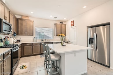 Kitchen featuring light tile patterned floors, lig