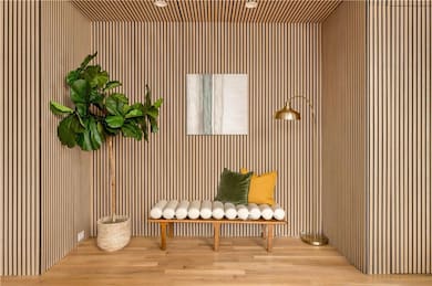 Sitting room with wood finished floors and wooden 