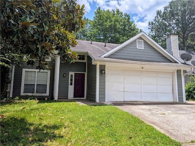 Single story home featuring driveway, an attached garage, a front lawn, and a chimney