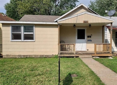 View of front facade featuring covered porch, a front yard, and roof with shingles
