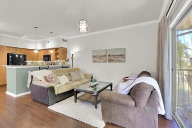 Living area with ornamental molding, dark wood-st