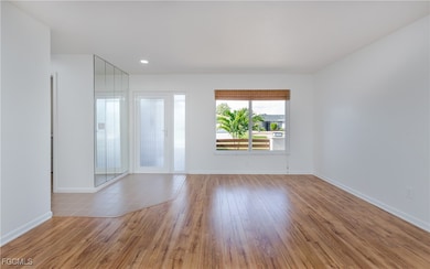 Spare room with wood finished floors and baseboards