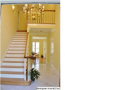 The large, open marble-floored foyer leads to the 