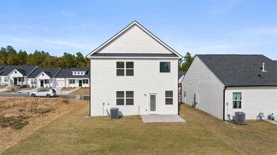 Back of property featuring a patio, a lawn, and a residential view