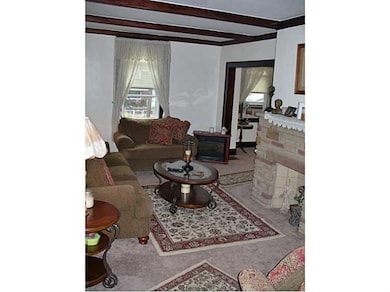 Living Room. Has original woodwork and wood beam c
