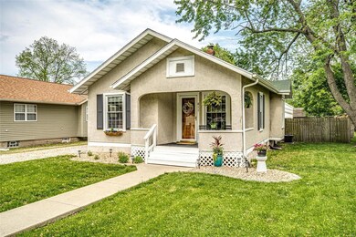 Welcoming front porch with room for chairs and a s