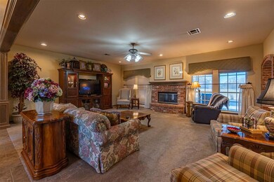 Living room featuring carpet floors, a fireplace, 