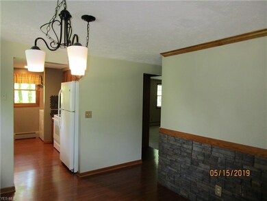 Wood floors flow into kitchen area plus laundry.