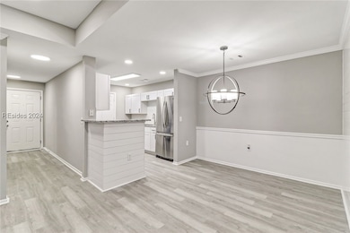 Kitchen featuring crown molding, stainless steel f