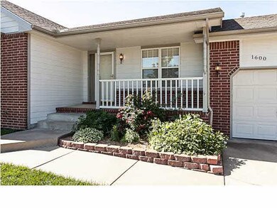 A nicely landscaped, welcoming covered front porch