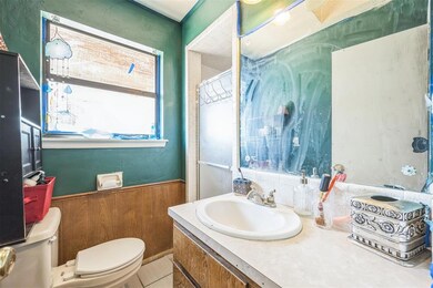 Bathroom with toilet, tile patterned flooring, van