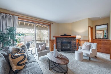 Gas fireplace with a hand-hewed wooden beam and st