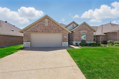 View of front of house featuring brick siding, a f